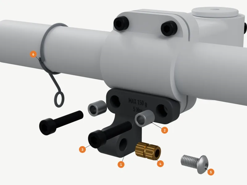 Exploded render: the tab stays under the faceplate, with two full-height steel sleeves and two black M5 bolts pulled forward out of the strap, the brass M6 insert and the M6 button-head lamp screw along the boss axis, and the tether cord round the bar with its eye, numbered as in the parts list.