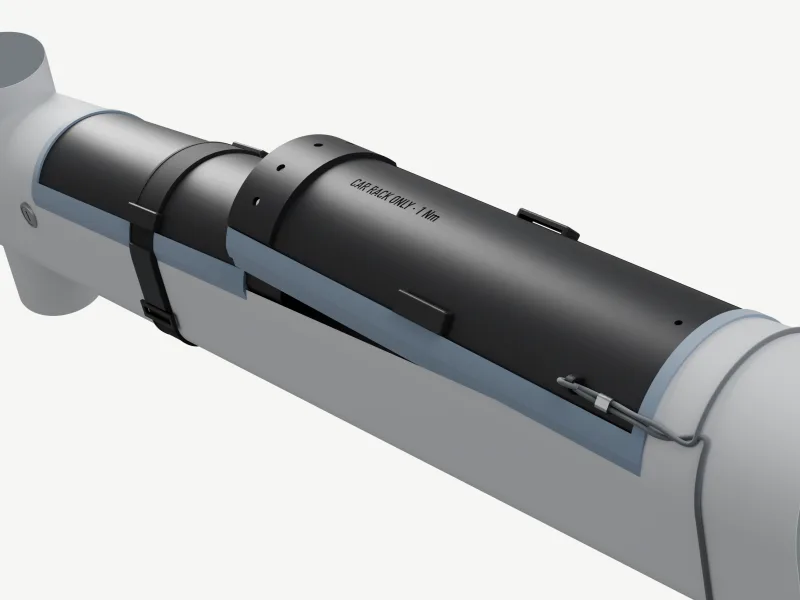 Render of a clay-grey down tube, bike upside down on a stand, the empty bay closed by our black two-part cover: a blue-grey TPU lip round its edge, the lap step in the middle with three M4 button heads and CAR RACK ONLY · 1 Nm debossed, two black straps round the tube and a tether at the far end.